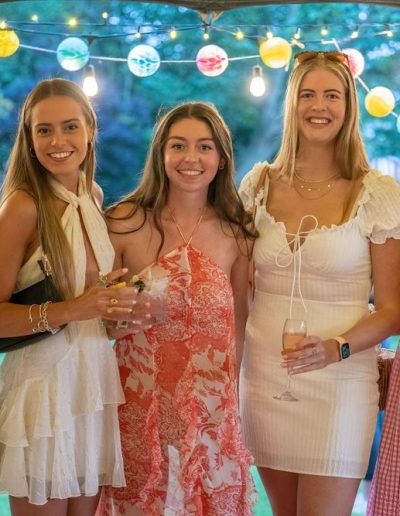 young women pose during a summer party photographed by small event photographers surrey social stock photography