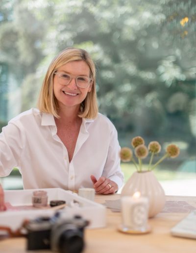 a woman works at her desk during a personal branding photography shoot in guildford