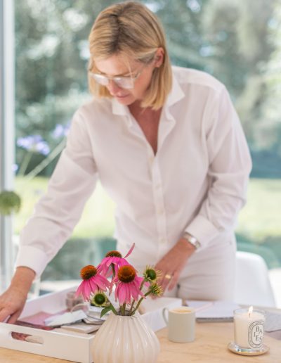 a woman works at her desk during a personal branding photography shoot in guildford