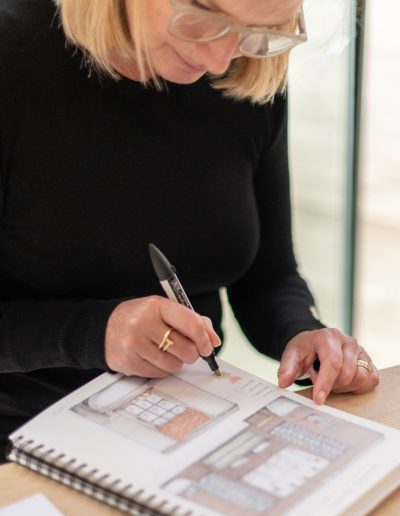 a woman works at her desk during a personal branding photography shoot in guildford