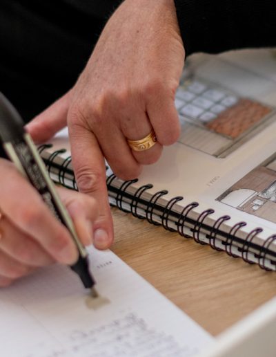 a woman works at her desk during a personal branding photography shoot in guildford