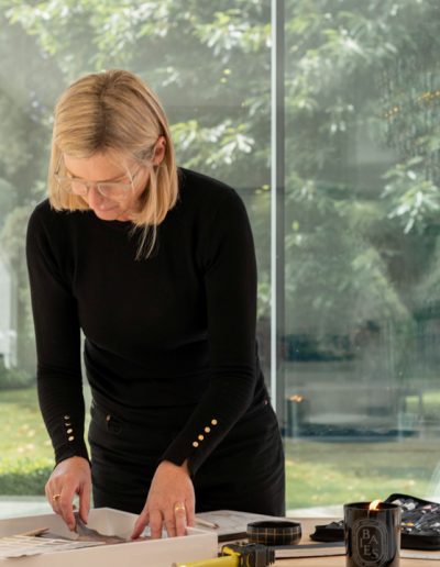 a woman works at her desk during a personal branding photography shoot in guildford