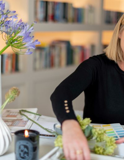 a woman works at her desk during a personal branding photography shoot in guildford