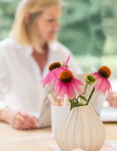 a woman works at her desk during a personal branding photography shoot in guildford