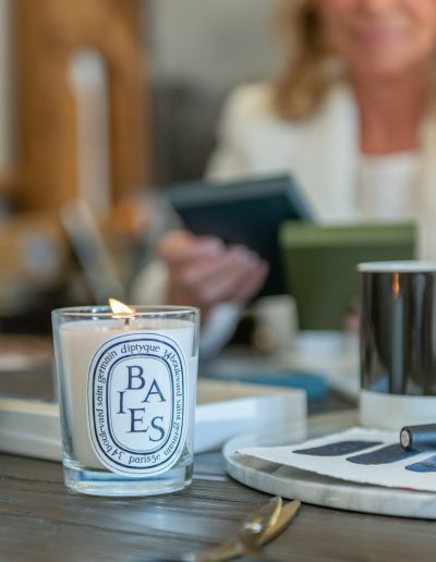 a woman looks at samples in her interior design studio during a personal brand photography shoot in guildford