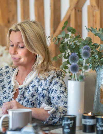 a woman looks at samples in her interior design studio during a personal brand photography shoot in guildford