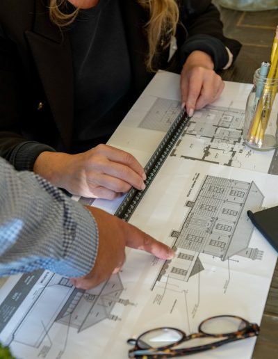 a man and a woman look at interior samples during a personal branding photography shoot in guildford