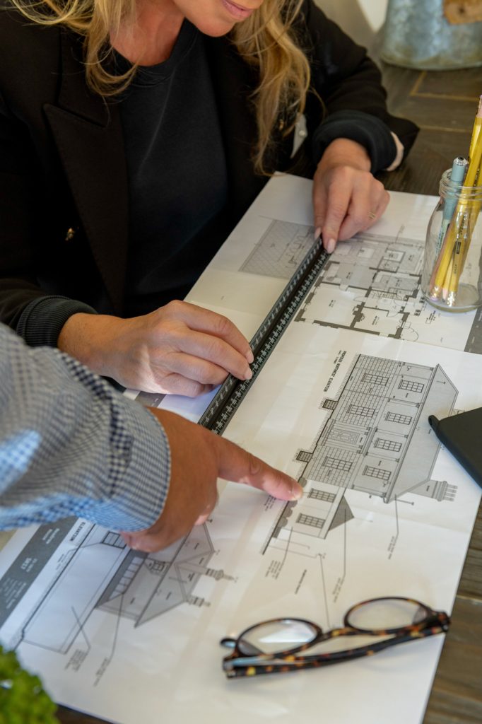 a man and a woman look at interior samples during a personal branding photography shoot in guildford