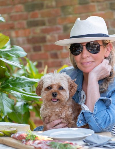a woman and her dog enjoy an al fresco lunch during a personal branding photography shoot in guildford