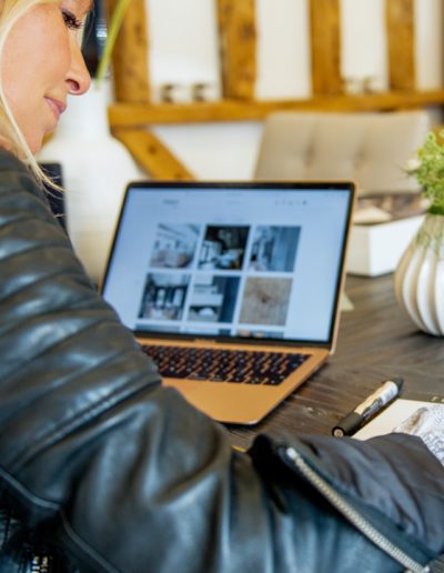 a woman works at her desk during a personal branding photography shoot in guildford