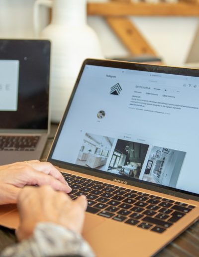 a woman works on her website during a personal brand photography shoot in guildford