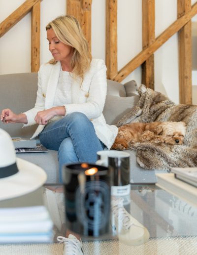 a woman looks at samples in her interior design studio during a personal brand photography shoot in guildford