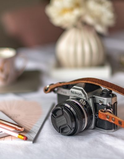 a vintage film camera on a desk during a personal brand photography shoot in surrey