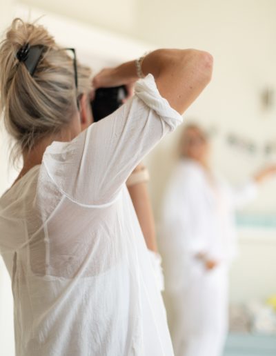 a woman takes a picture of her subject during a personal branding photography shoot in guildford