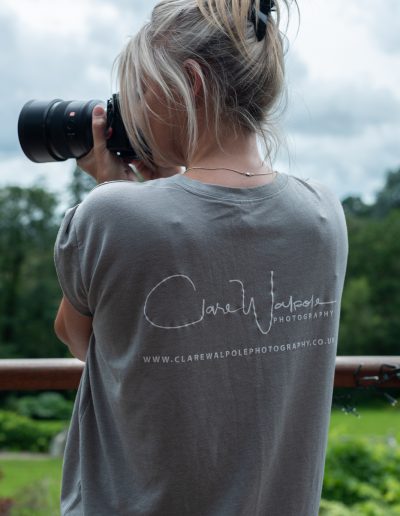 a woman takes a picture of a landscape during a personal branding photography shoot in surrey