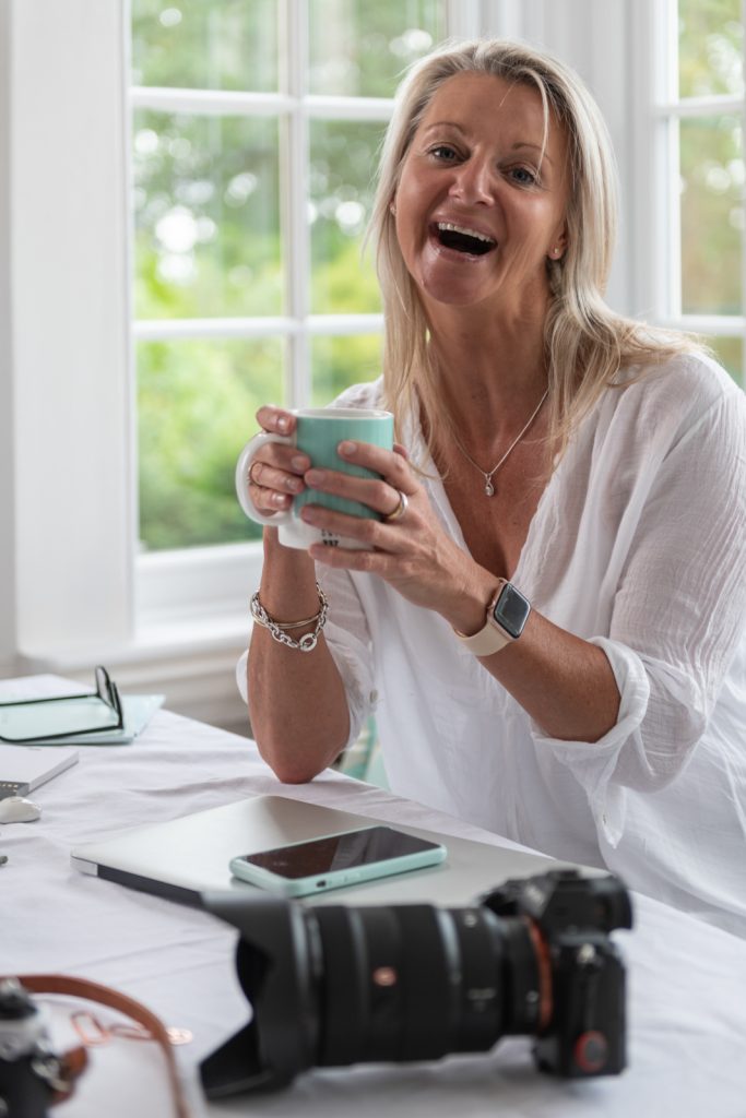 a woman laughs at the camera during a personal brand photography shoot in surrey