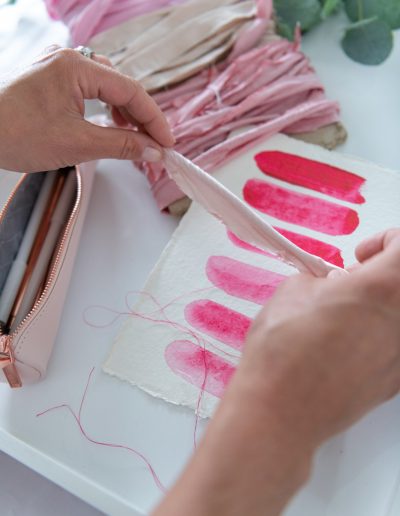 pink ribbons and paint props during a personal branding photography shoot in surrey
