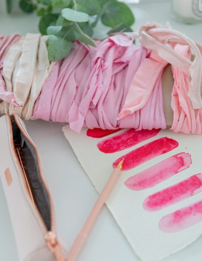 pink ribbons and paint props during a personal branding photography shoot in surrey