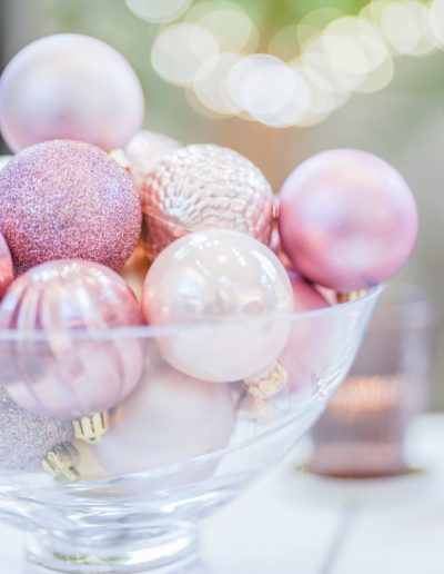 a bowl of pink christmas decorations during a product photography shoot in london