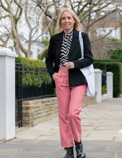 a young woman walks down a london street during a personal brand photography shoot