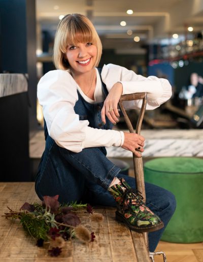a young woman poses with a garden fork during a lifestyle photography shoot in guildford