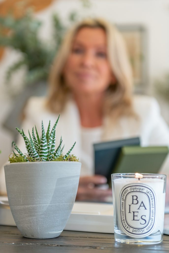 a woman looks at interior samples at her desk during a personal brand photoshoot in guildford