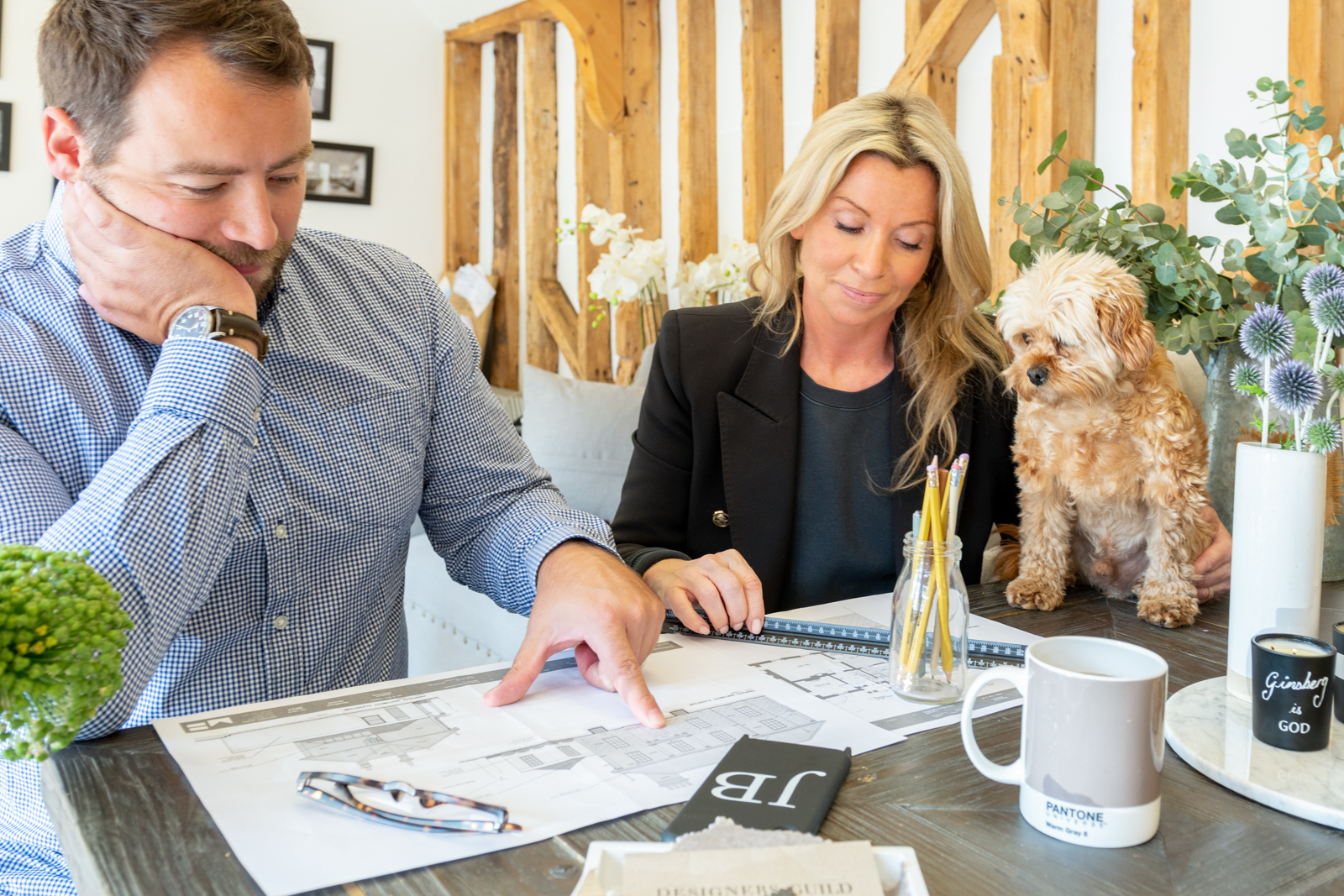 a man and a woman look at interior samples during a personal branding photography shoot in guildford