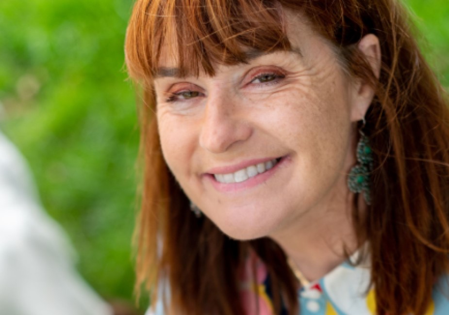 smiling woman in colourful blouse during a personal branding photography shoot in surrey