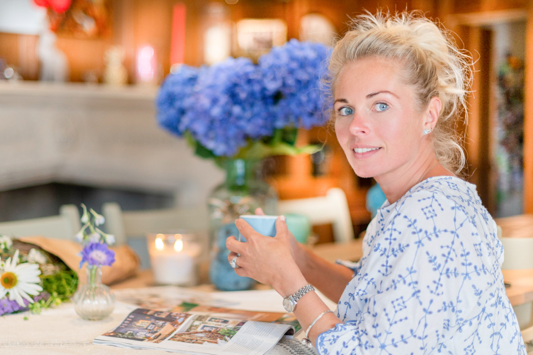 woman sitting at her kitchen table with a cup of coffee