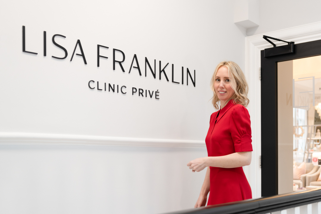 woman in a red dress outside lisa franklin skincare clinic in london