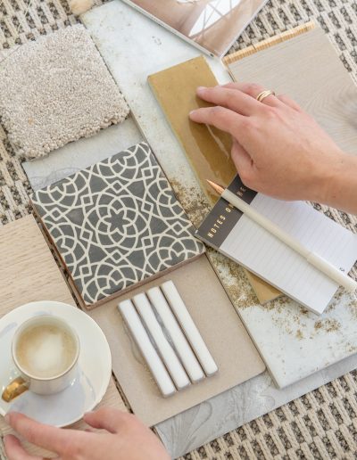 a woman looks at samples in her interior design studio during a personal brand photography shoot in guildford