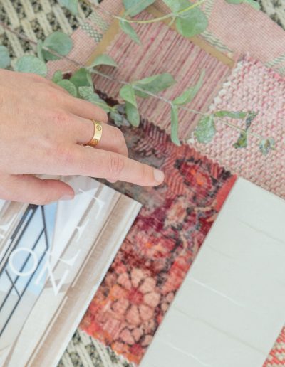 a woman looks at pink samples in her interior design studio during a personal brand photography shoot in guildford