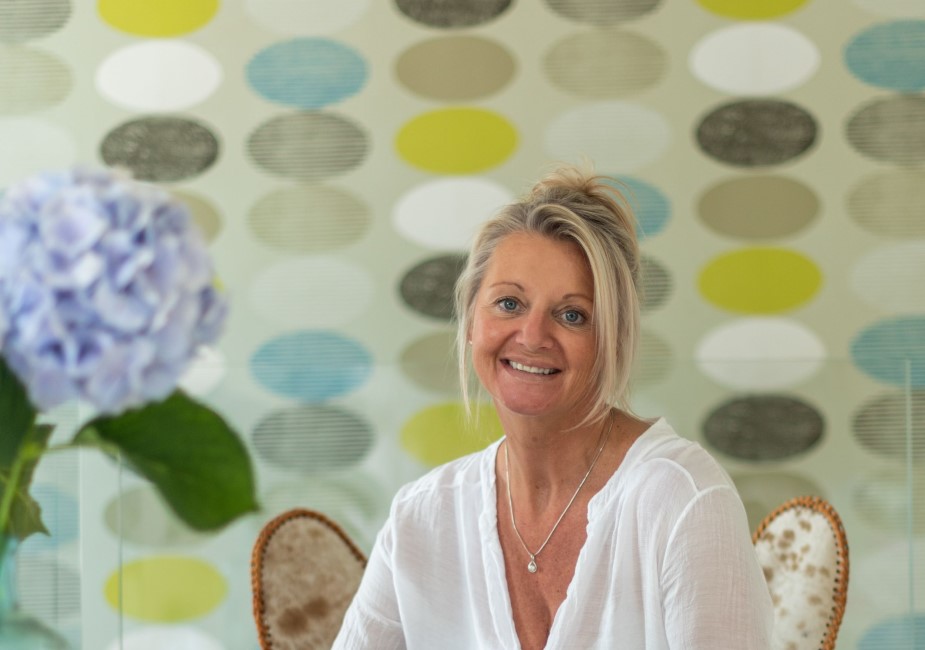female photographer posing on a chair for a personal branding photography shoot in surrey