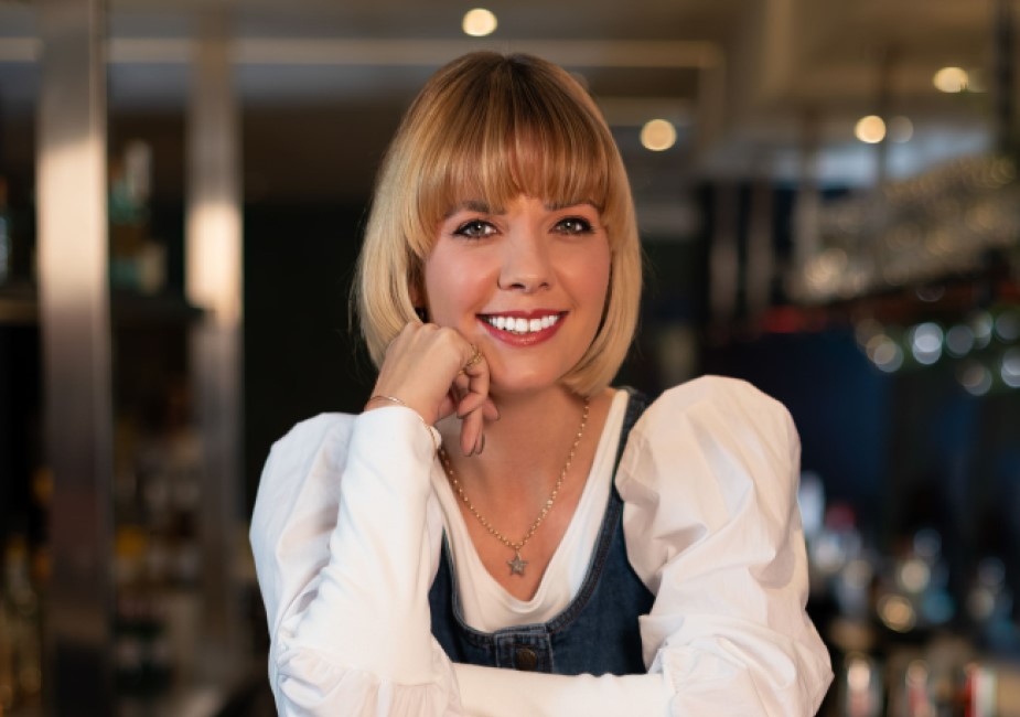 natural girl with bob hair cut sitting on bar in dungarees during a surrey photoshoot