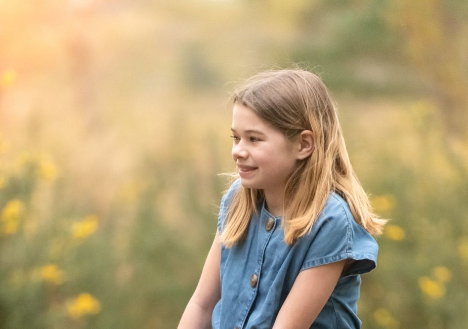 young girl in a field of grass during a lifestyle photoshoot in surrey