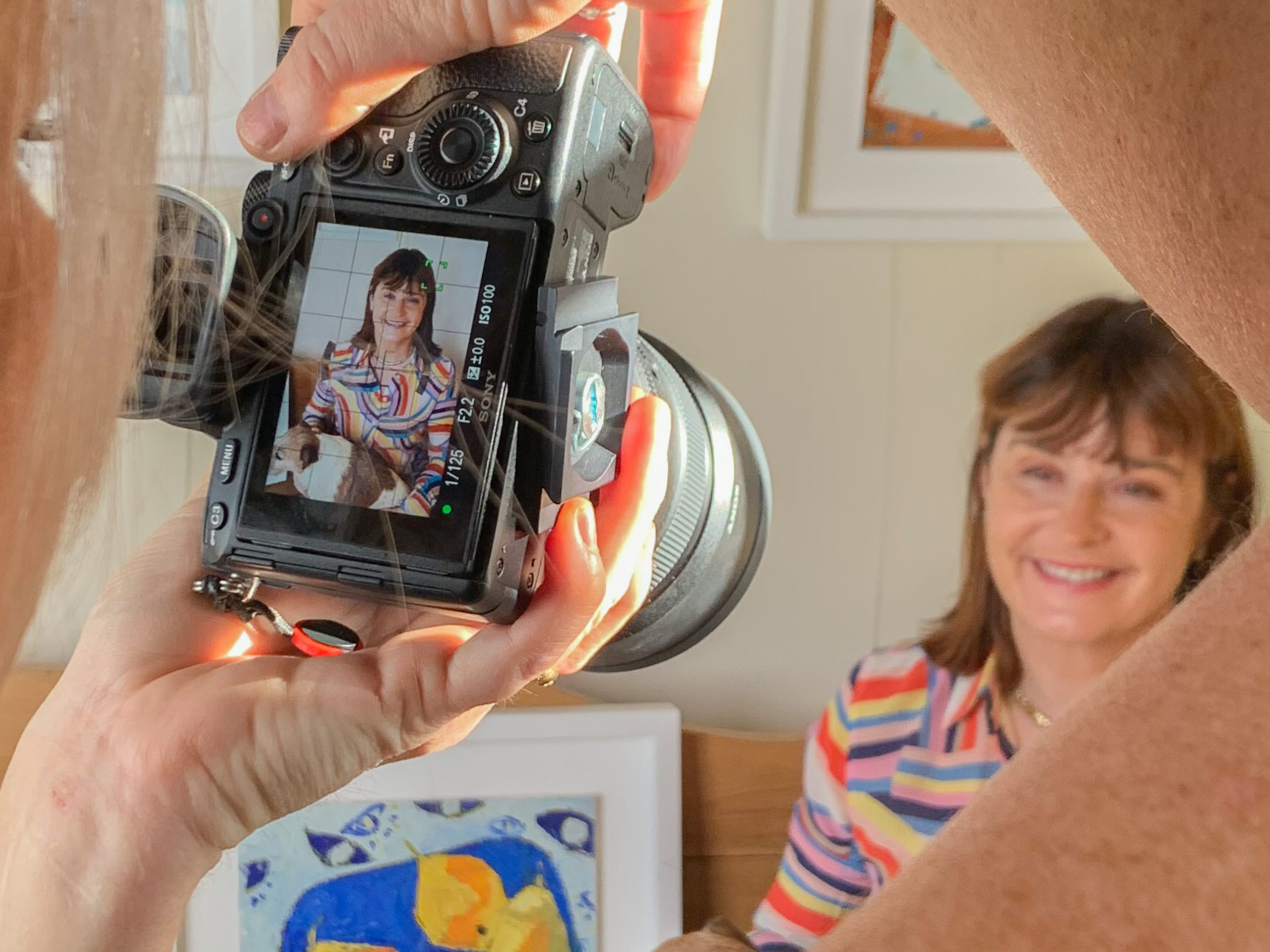 a photographer takes a portrait of a woman during a personal brand photography shoot in guildford