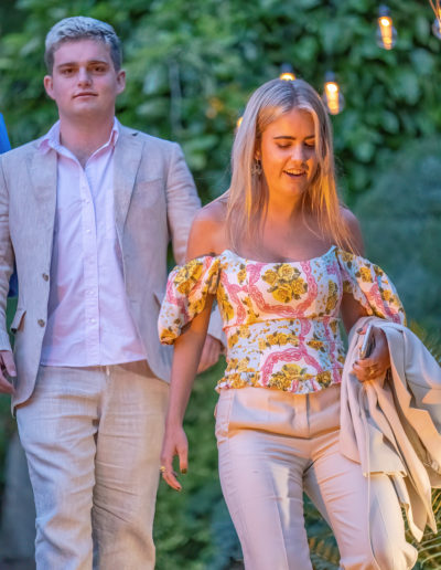 two people arrive at a summer party shot by surrey social stock photgoraphy