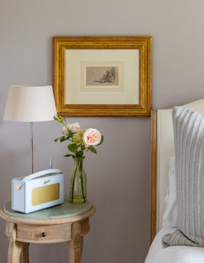 a vintage side table in a bedroom styled for an interior photo shoot in guildford