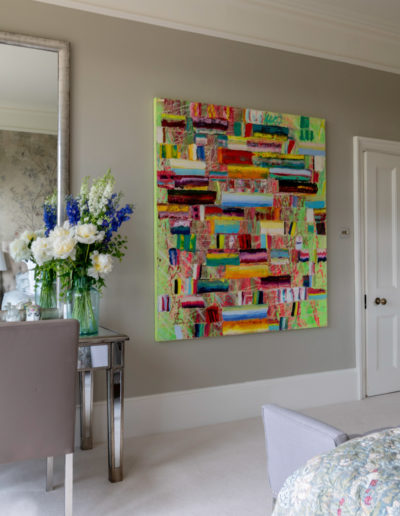 a colourful painting in a bedroom styled for a lifestyle photography shoot in guildford
