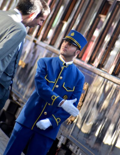 a butler on the orient express direct people on board shot by travel photographers surrey social stock photography