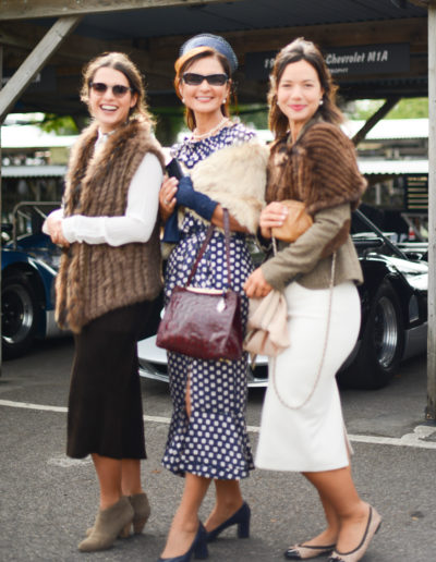 three women in vintage clothes pose at goodwood revival