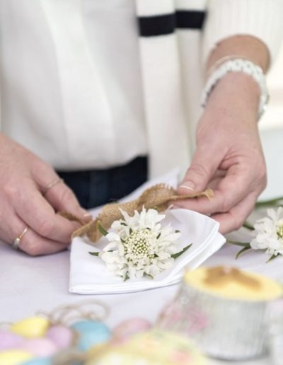 a woman makes a table placement during a lifestyle photography shoot in surrey