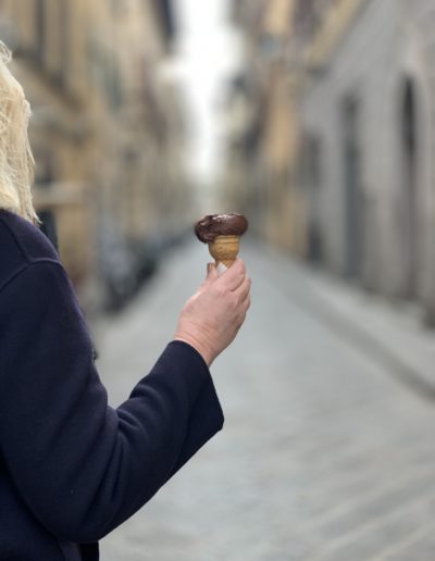 a woman holds a gelatto in florence shot by travel photographers surrey social stock photography
