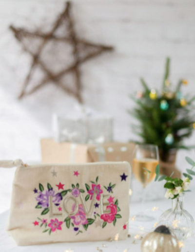 an embroidered bag being wrapped for christmas