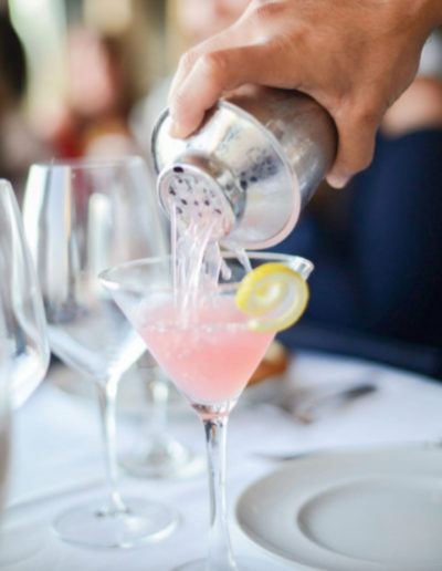 a cocktail waiter pours a cocktail at a restaurant