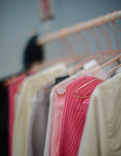 a rack of bright clothes