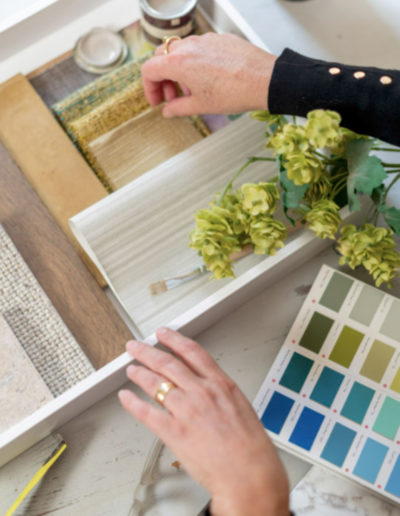 an interior designer checks her samples in a tray