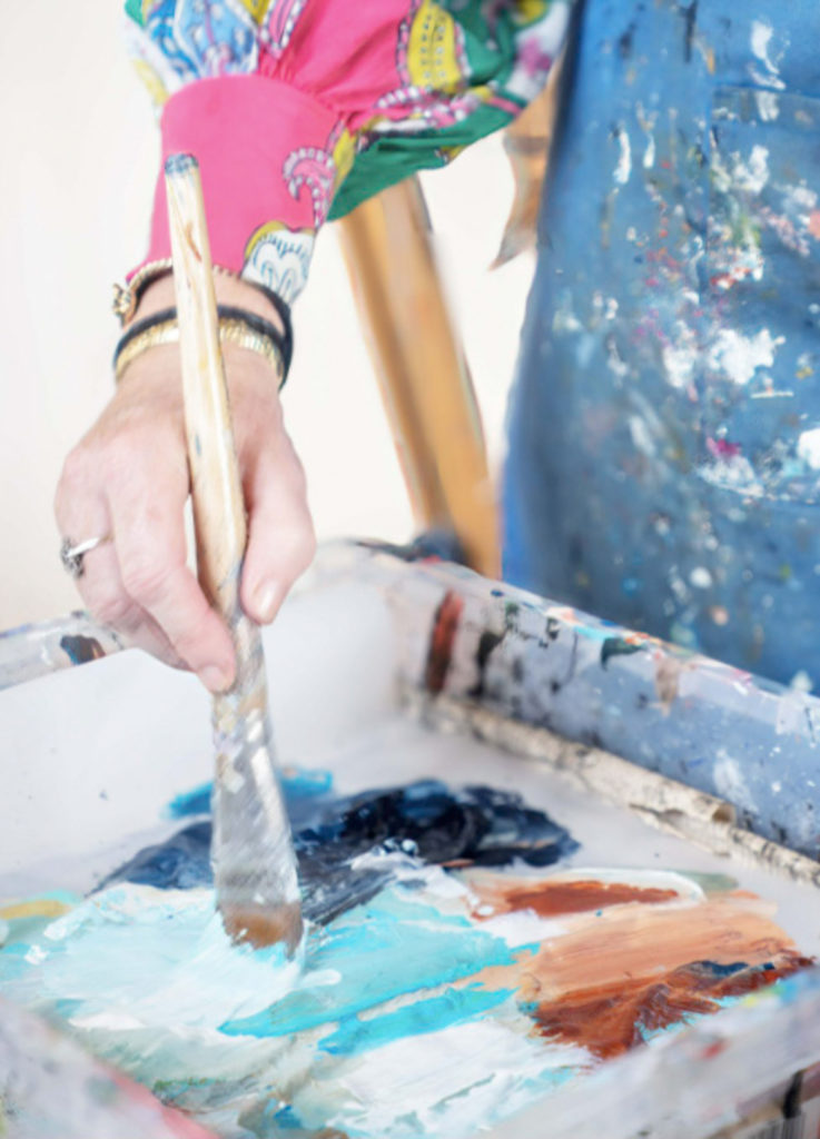 an artist mixes her paints during a personal brand photography shoot by surrey social stock photography