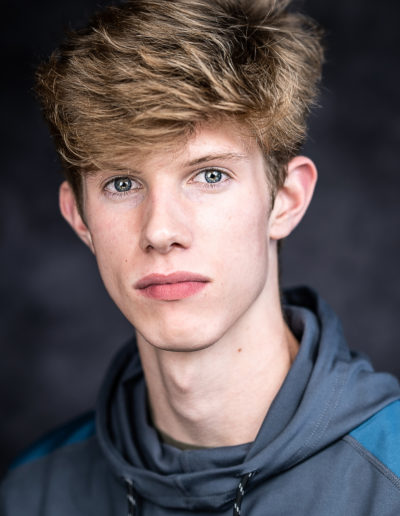 a young actor poses for a headshot photo with surrey headshot photographers surrey social stock photography