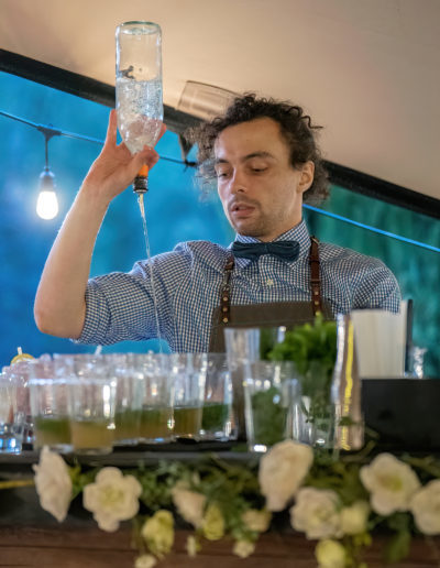a cocktail barman pours cocktails during a business photography shoot by surrey social stock photography